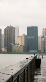 Buildings in city against sky during winter