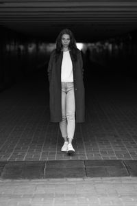 Low section of woman standing on street