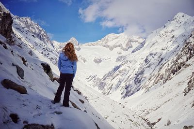 Woman on snow covered mountain