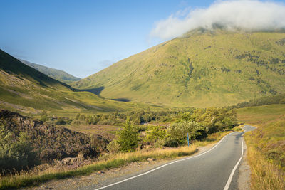 Scenic view of a hill and single track road in glencoe, scotland