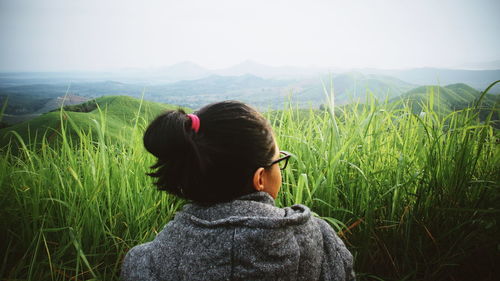 Rear view of woman looking at field