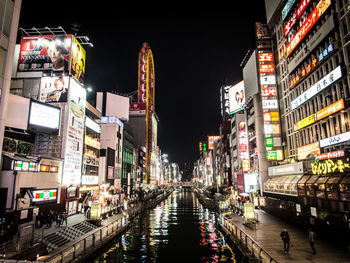 Illuminated city against sky at night