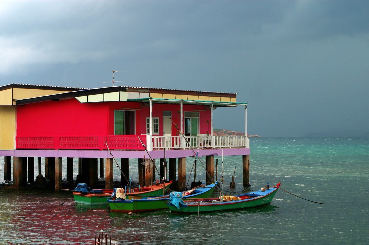 water, sea, built structure, architecture, sky, building exterior, waterfront, horizon over water, cloud - sky, beach, nautical vessel, boat, tranquility, nature, tranquil scene, cloud, outdoors, house, pier, day