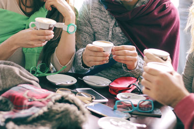 Group of people in drinking glasses on table