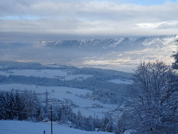 Scenic view of snow covered mountains against sky