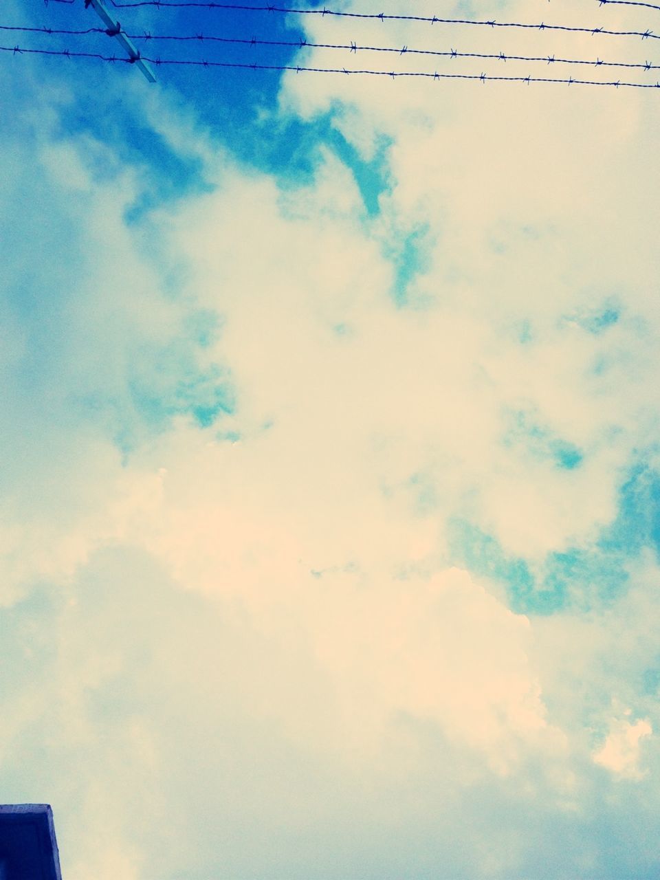 sky, low angle view, cloud - sky, blue, cloud, cloudy, built structure, building exterior, day, nature, no people, outdoors, architecture, cloudscape, high section, beauty in nature, power line, scenics, tranquility, backgrounds