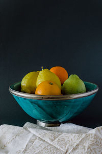 Turquoise bowl of refreshing citrus, orange, lemon and lime.