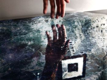 Digital composite image of hands touching human hand