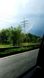 View of trees seen through car windshield