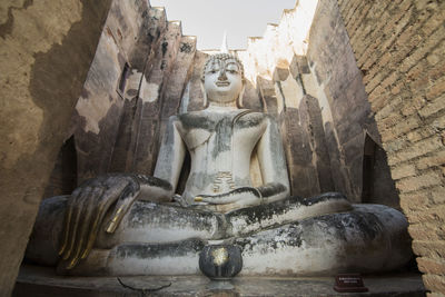 Low angle view of statue against historic building