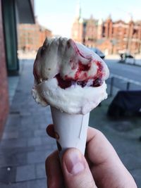 Close-up of hand holding ice cream cone