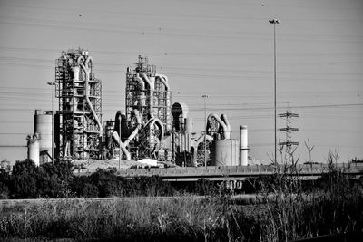Abandoned machinery on field against sky