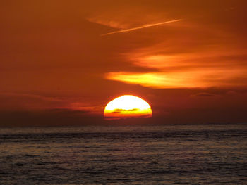 Scenic view of sea against romantic sky at sunset