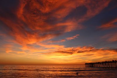 Scenic view of sea against orange sky