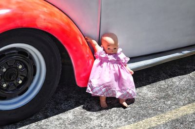 Full length of cute girl standing in car