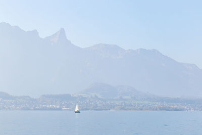 Scenic view of sea and mountains against sky