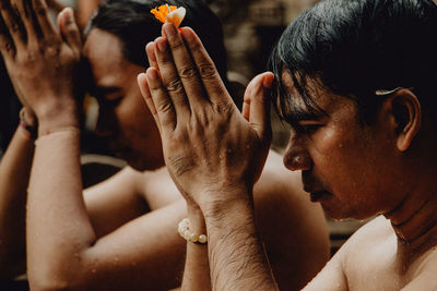 Close-up portrait of man holding hands