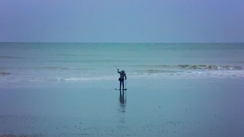 Man on beach against sky