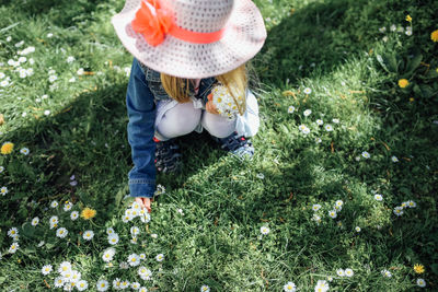 Rear view of woman wearing hat on field