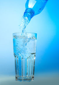 Close-up of wine glass against blue background