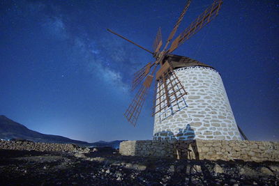 Low angle view of traditional windmill against sky
