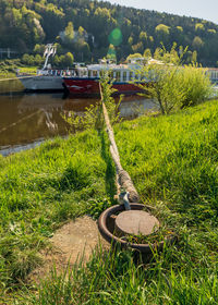 Abandoned boat moored by lake