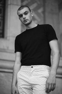 Portrait of young man standing outdoors