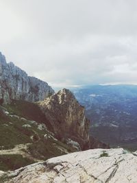 Scenic view of mountains against cloudy sky