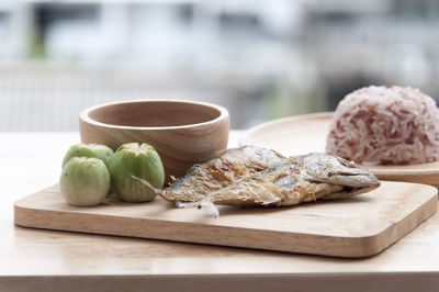 Close-up of seafood and rice served in plates on table