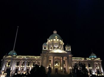 Low angle view of illuminated cathedral against sky at night
