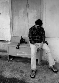 Man sitting on sideboard in abandoned building