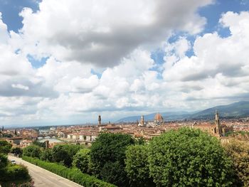 View of townscape against cloudy sky