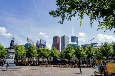 Panoramic view of buildings against cloudy sky