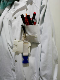 Office supplies in pocket of lab coat at hospital