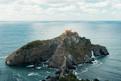 Scenic view of rock formation in sea against sky