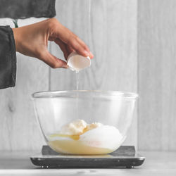 Midsection of person preparing food in kitchen