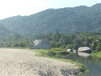 Scenic view of lake and mountains against sky