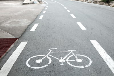 High angle view of arrow symbol on road in city