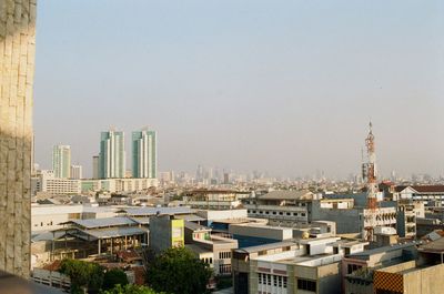 Buildings in city against clear sky