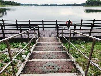 High angle view of empty walkway by lake