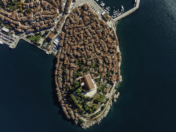High angle view of buildings by sea in city