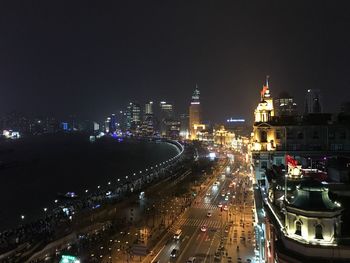 High angle view of illuminated cityscape against sky at night