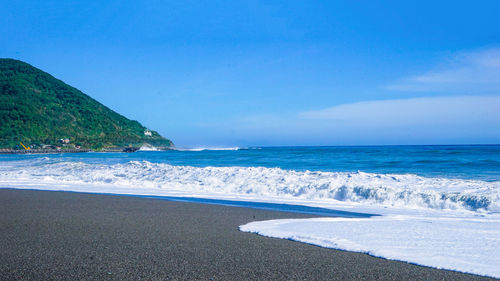 Scenic view of sea against blue sky