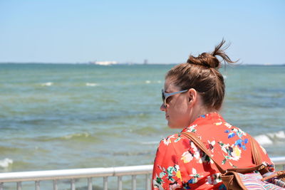 Rear view of woman looking at sea against sky