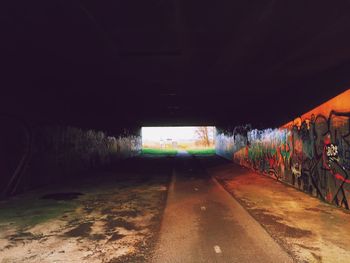 Illuminated tunnel at night
