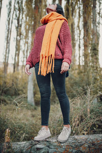 Rear view of woman standing in forest