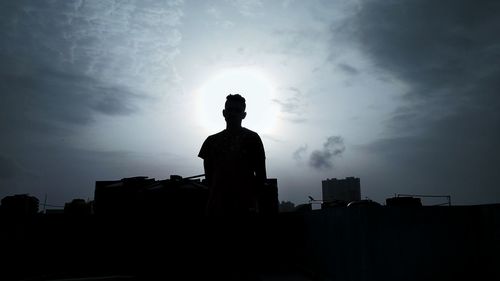 Low angle view of man against building against sky