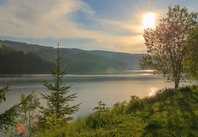 Scenic view of lake against sky during sunset