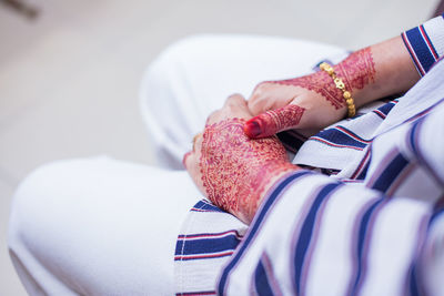 Midsection of woman with henna tattoo