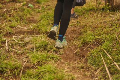 Low section of person standing on field